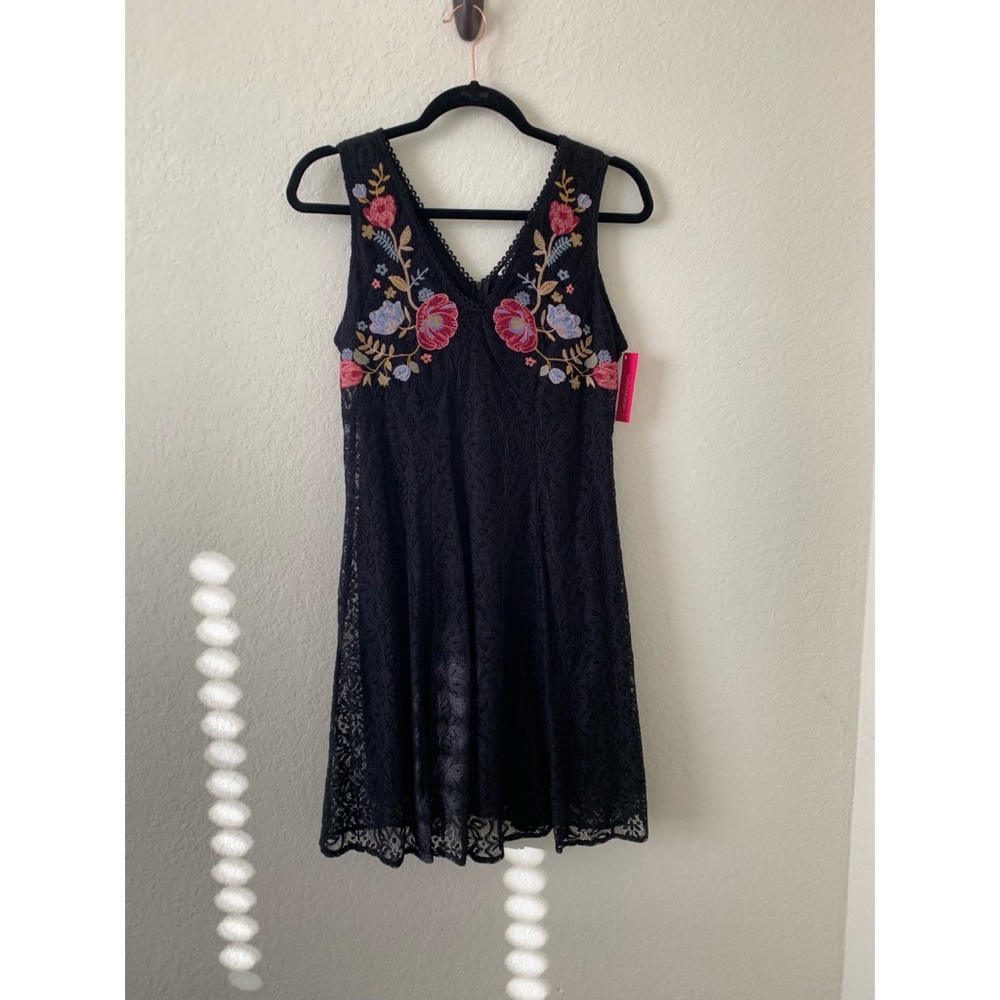 Women’s black short dress with embroidery on front. Size M. NWT